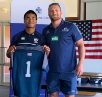 Tony Lamborn hands Tohi Angilau his game jersey.