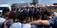 Both HS All Americans and New Zealand Fiji huddle up.