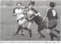 Ines Rodriguez handles some attention while playing for Keystone vs the Village Lions. Rugby Magazine photo.