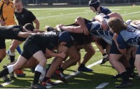 Kingfishers, in black, scrum down during a preseason scrimmage.