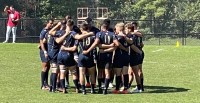 Navy huddles up. Jim Bell photo.