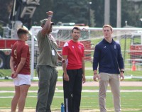 Retired Staff Sgt. Ray Wilson flips the coin. Alex Goff photo.