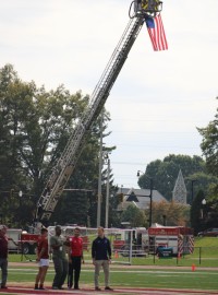 Retired Staff Sgt. Ray Wilson flips the coin. Alex Goff photo.