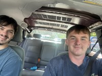 Nick Trout, right, and Caden Sims, left, in the car after the bear had ripped up the roof lining.
