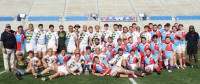 The teams pose together post-match.