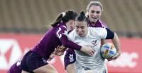 Kristi Kirshe battles through contact against England earlier in the tournament. Martin Seras Lima photo.