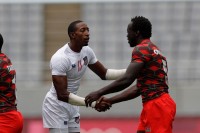 A little handshake. Perry Baker didn't see the ball in his first game. Mike Lee KLC fotos for World Rugby.