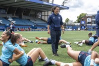 Assistant Coach Kelly Griffin runs the warmup. Photo Tim Anger @timangerphoto.