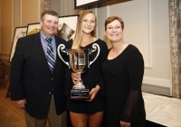 McKenzie Hawkins received the award in 2018, and poses with her trophy and her parents at the WAC in Seattle.