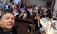 Alex Goff takes a selfie at the 2019 dinner. Sorensen winner Emily Henrich is just to the right of Goff.