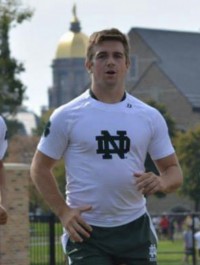 Plantz runs out onto the field in front of the Golden Dome at Notre Dame. Photo Notre Dame Rugby.